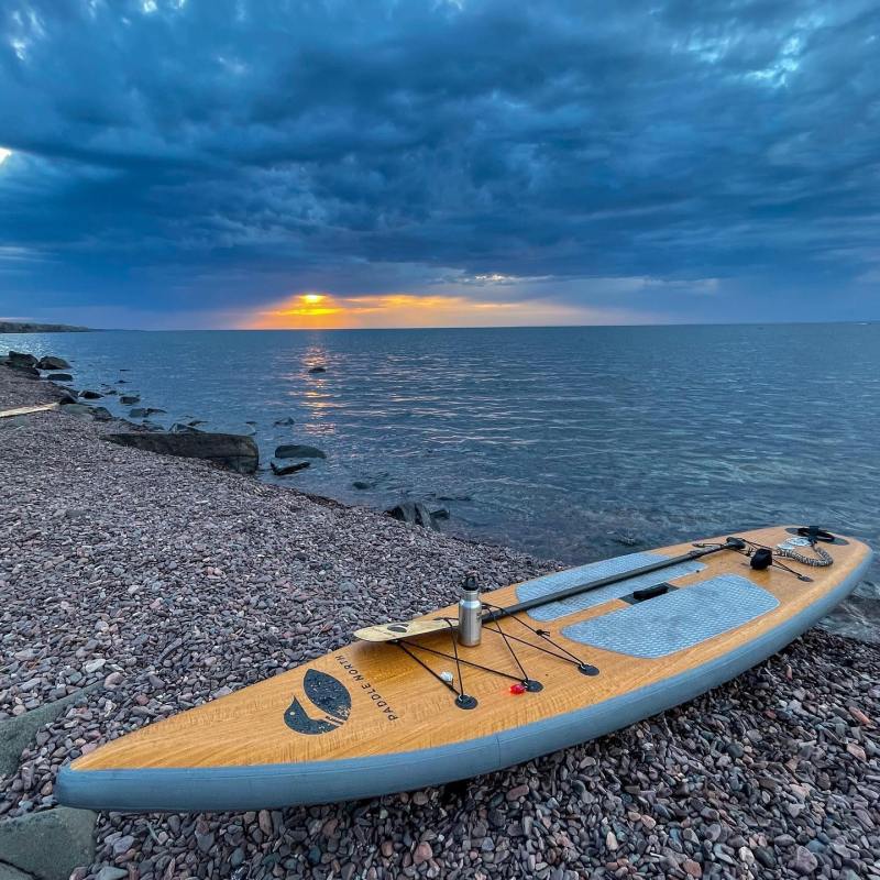 a beach with a paddl board on a body of water