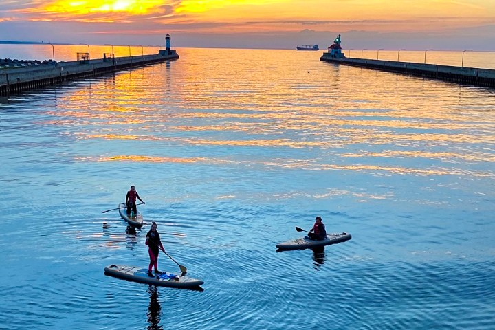 a group of people in a boat on a body of water