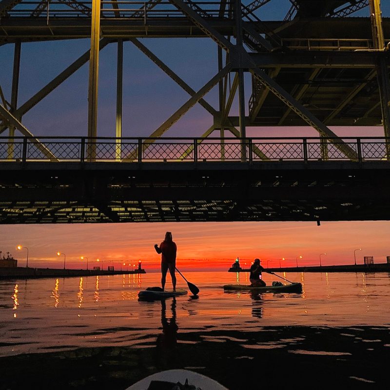 people kayaking at dusk