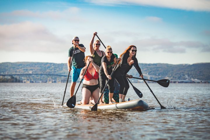 Group of people on a large paddleship paddling