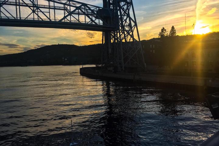 a train crossing a bridge over a body of water