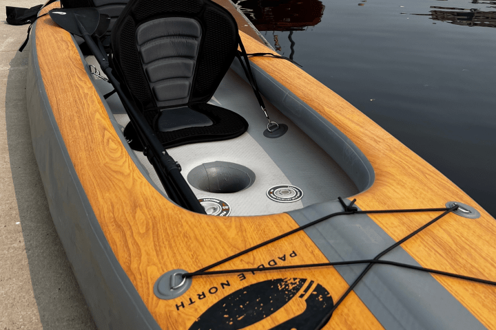 tandem inflatable kayak sitting on dock in front of large freighter in Duluth