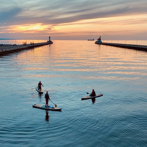 a group of people riding skis on a body of water