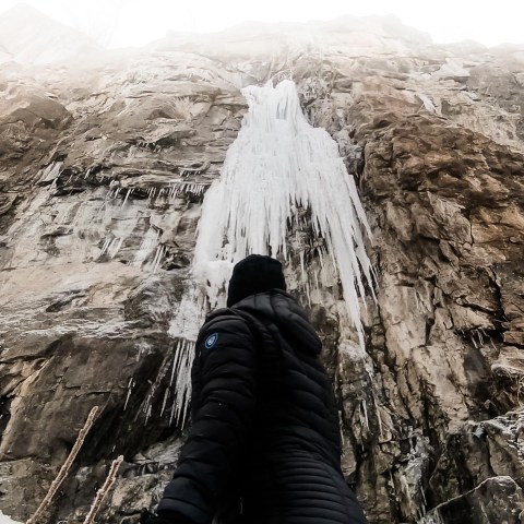 a person standing in front of a mountain