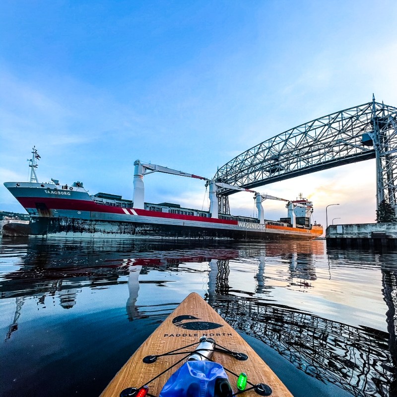 paddle boarding on Lake Superior next to a freighter