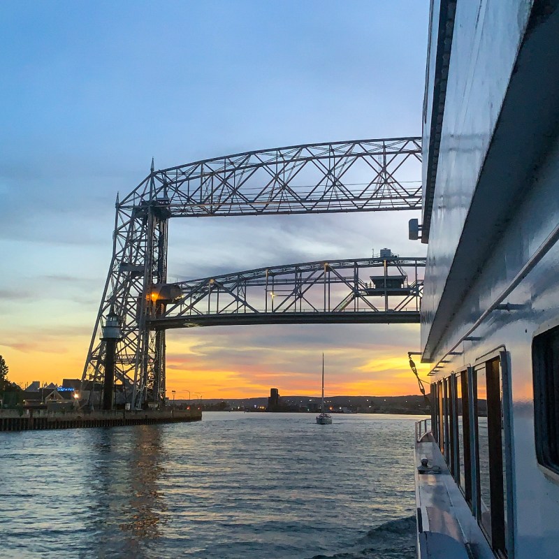 boat traveling under the Aerial Lift Bridge
