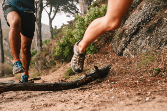 Two people running on a trail
