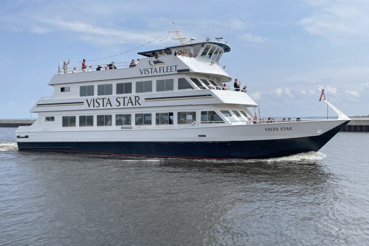 White ferry named Vista Star on water under blue sky.